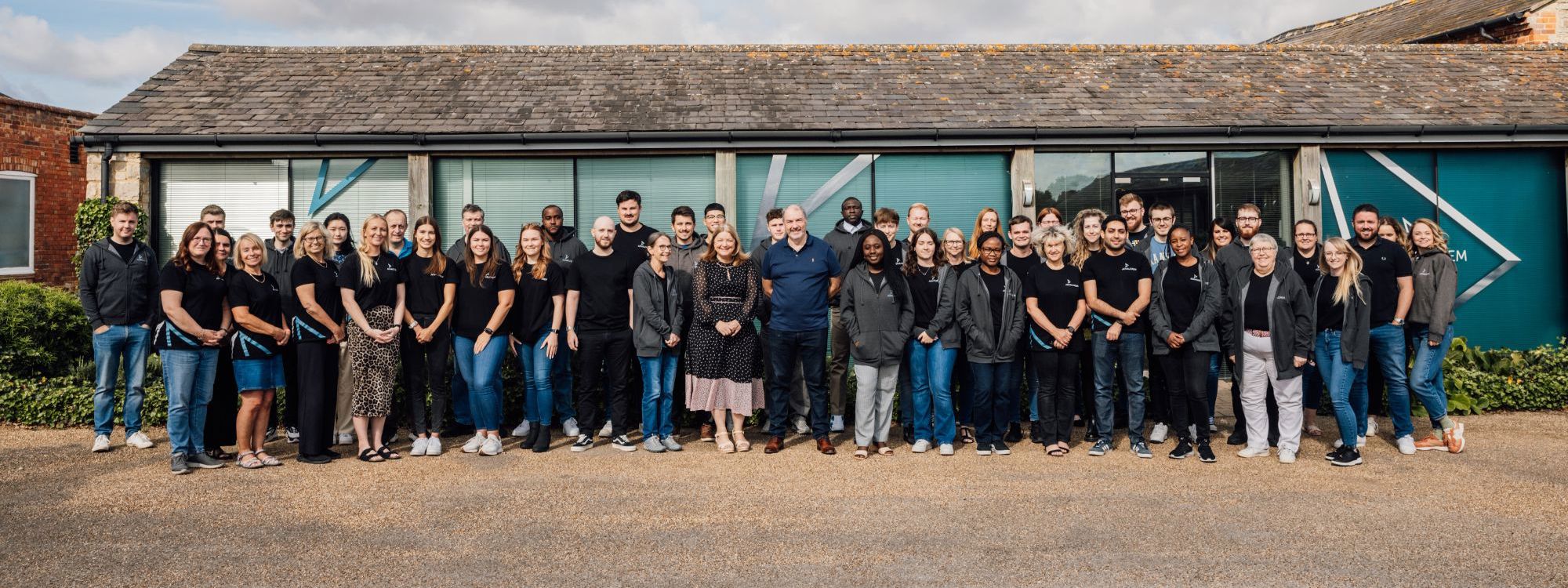 Ad Valorem Team stood outside Manor Farm Court building