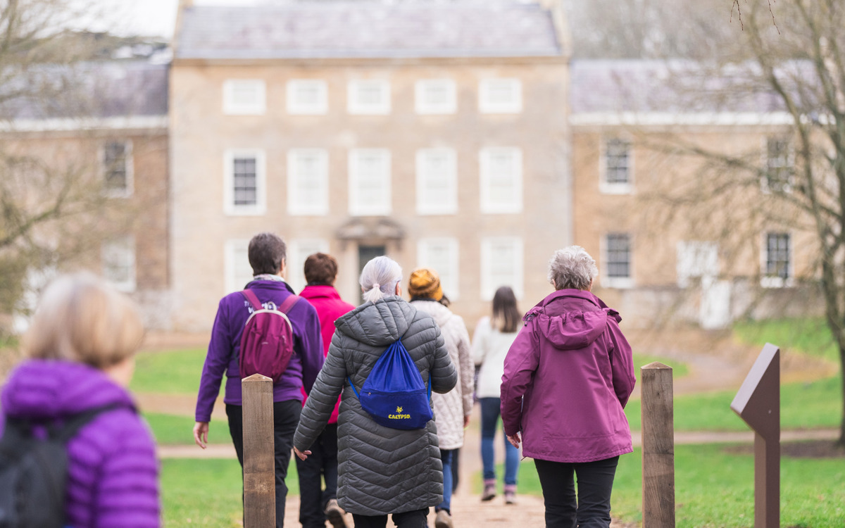Walkers in front of Great Linford Manor house.