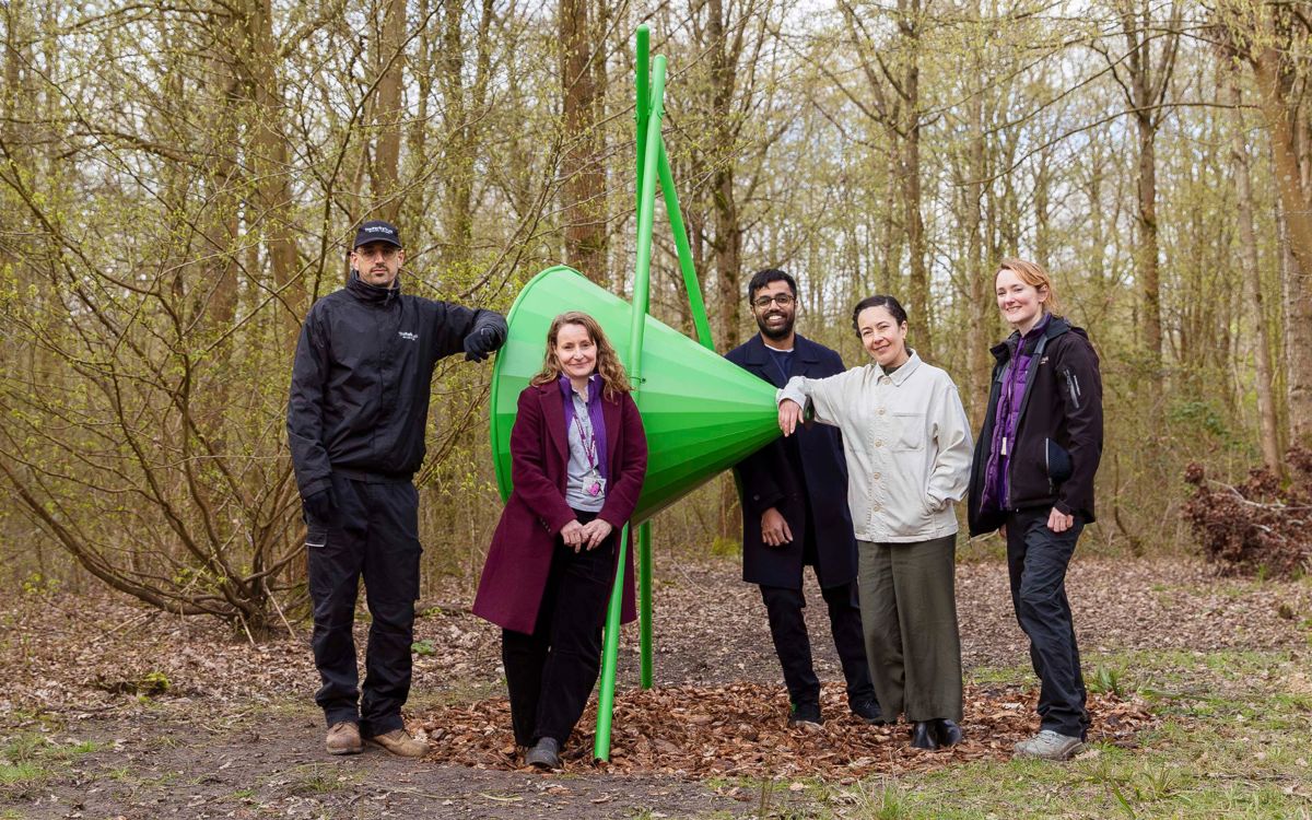 Group of people with large metal cone