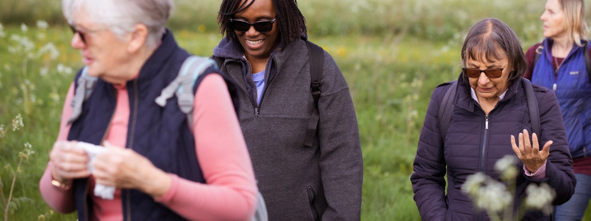 A group of women walking through parkland