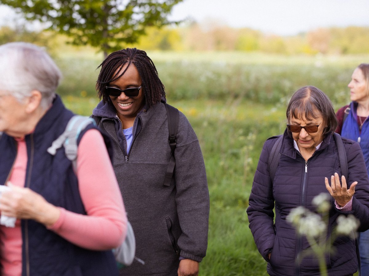 A group of women walking through parkland