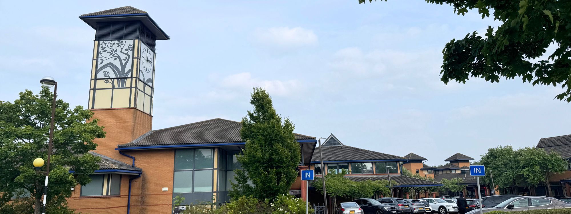 view of the entrance to the local centre shops with iconic clock tower