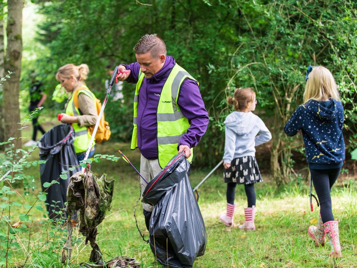 Ranger picking up litter in the park