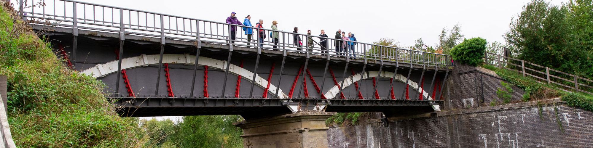 People standing on iron aqueduct bridge
