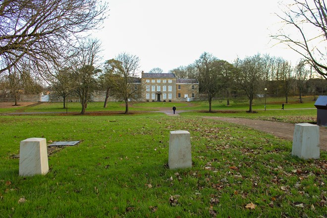 View to Manor with white bollards in foreground.
