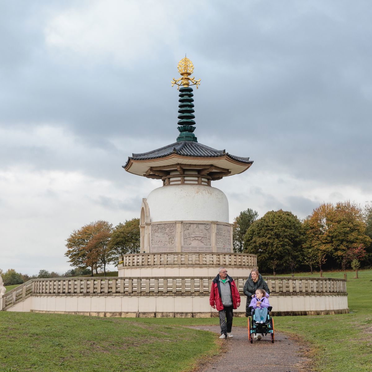 Large Peace Pagoda monument with family walking on path