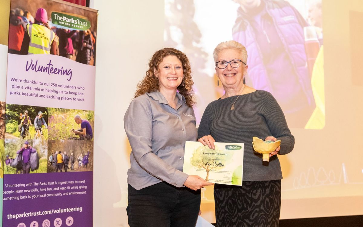 Parks Trust staff member presenting award to Ann