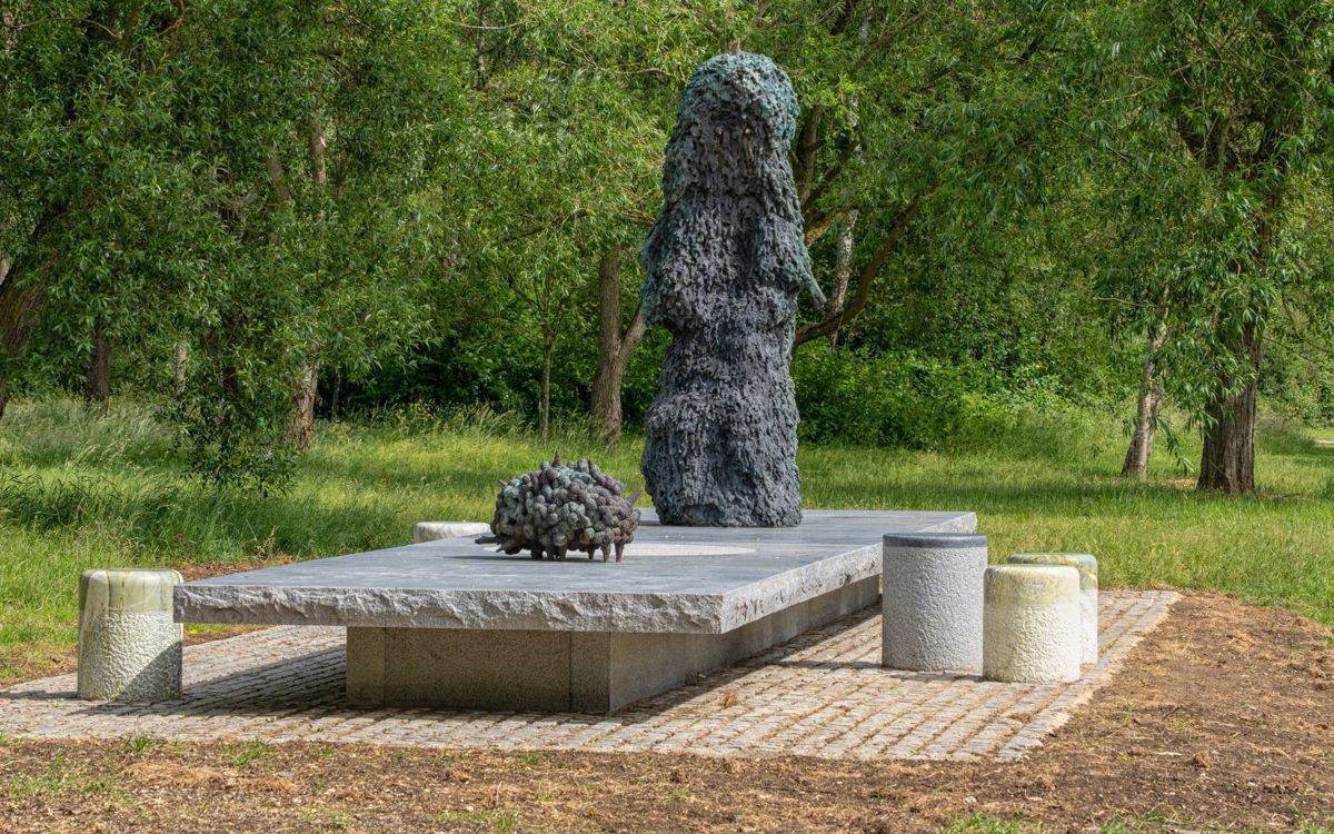 Art sculpture in parkland with trees behind