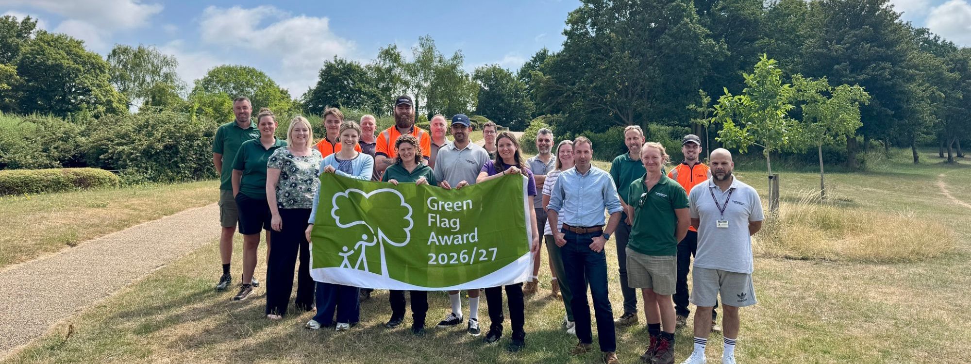 Group photo of Parks Trust staff holding Green Flag