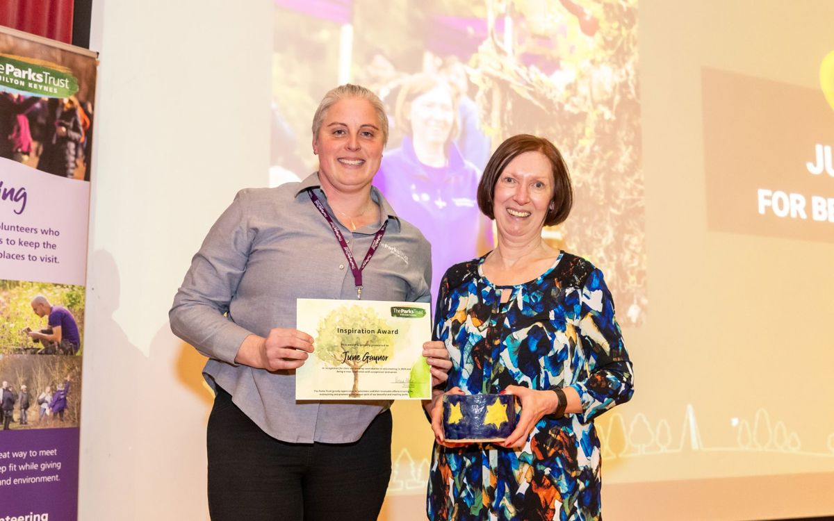 Outdoor learning leader presenting award to June