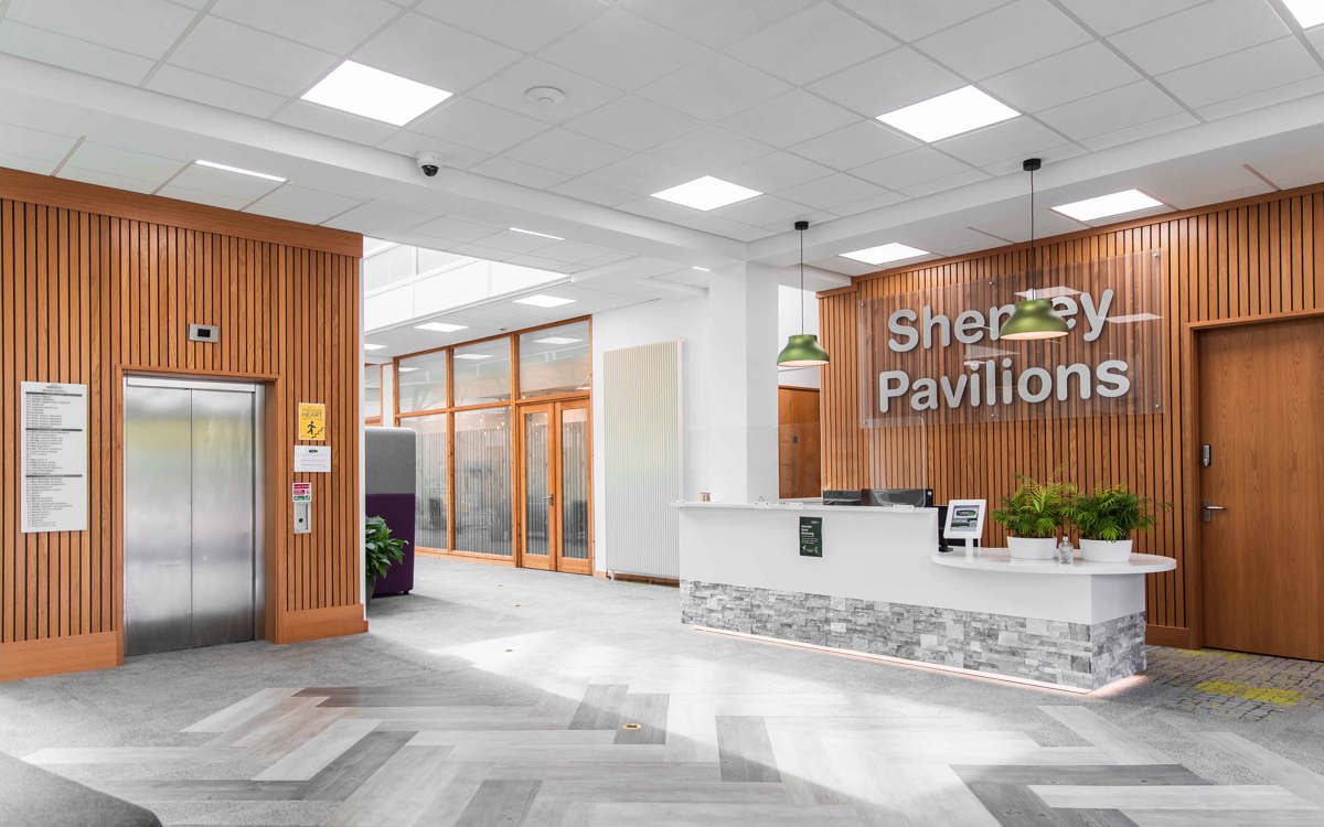 Reception area with welcome desk, seating and access to the elevator