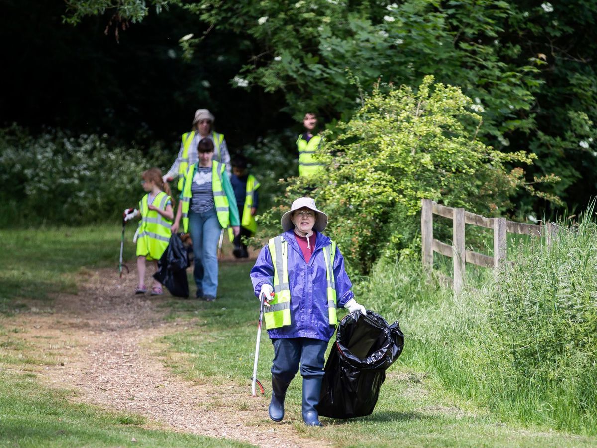 People picking litter at a community litter pick event in the park