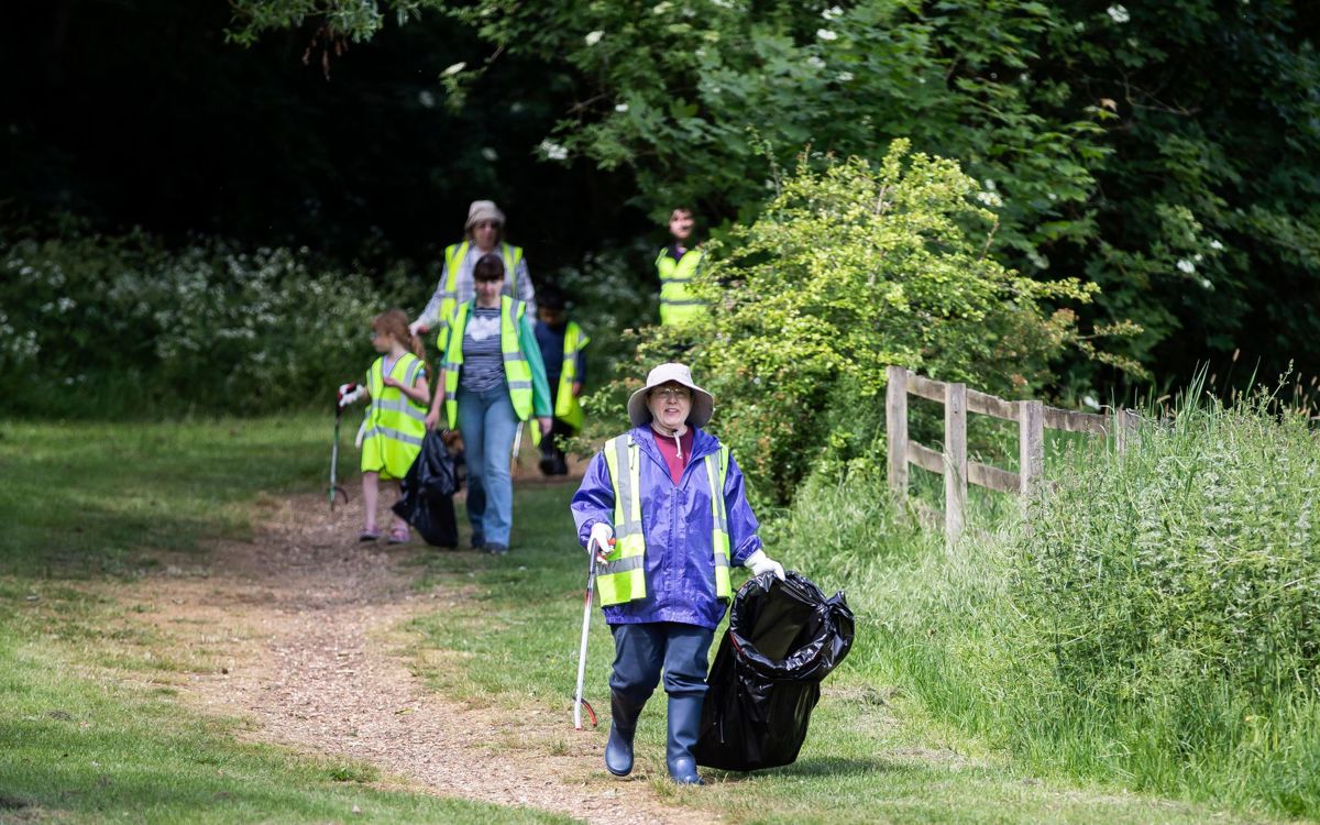 People picking litter at a community litter pick event in the park