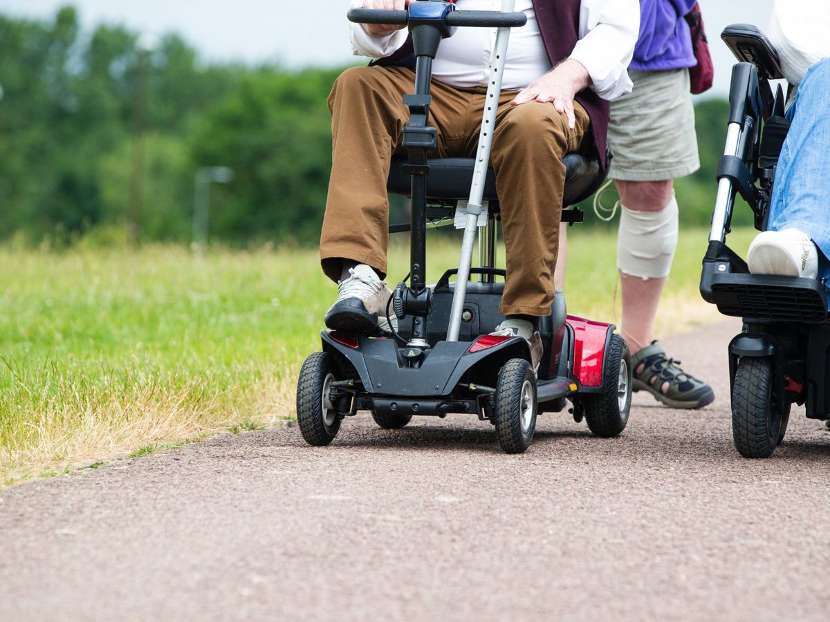 People walking and moving with motorised wheelchair and scooter