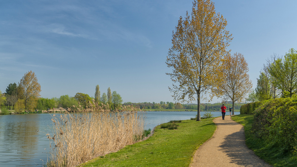 Person running along lakeside footpath, Furzton Lake.