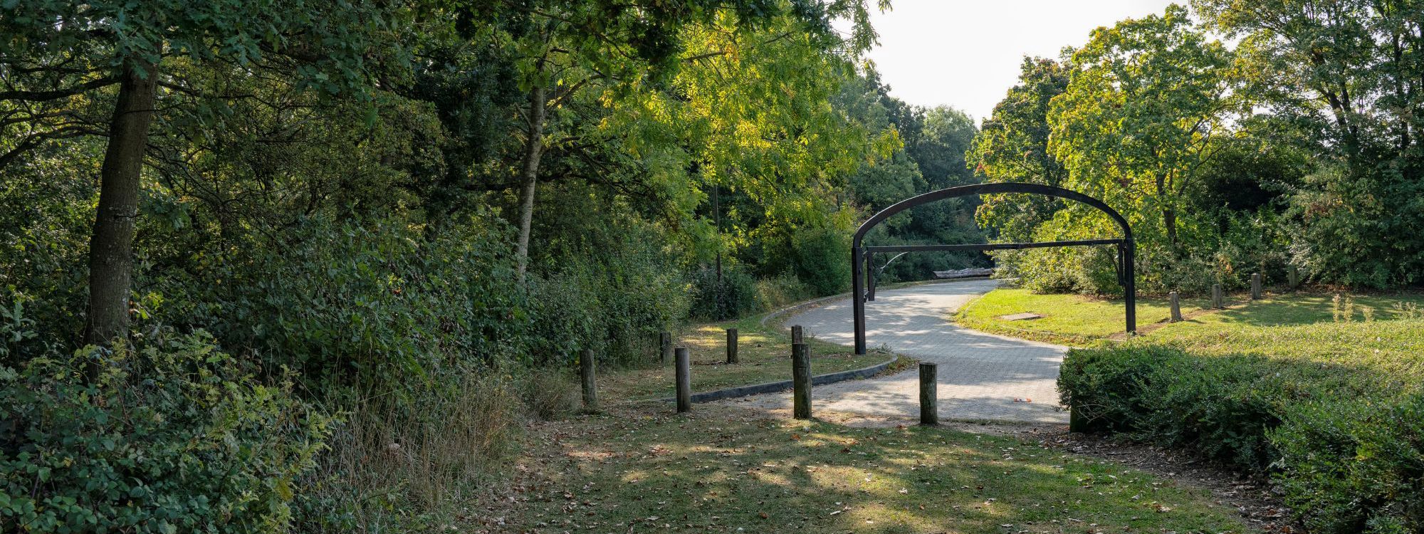 Entrance to Linford Wood car park with trees and height barrier
