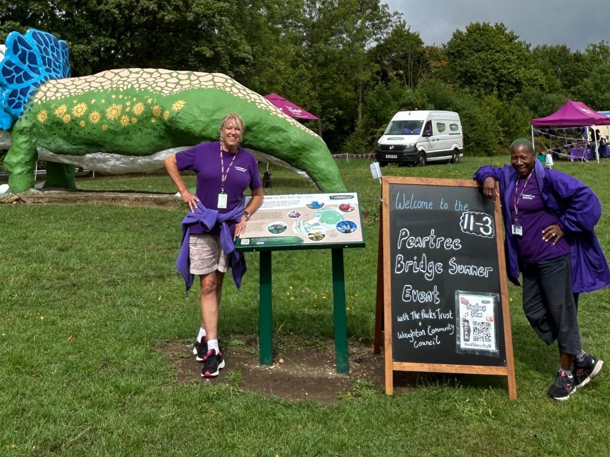 Parks Trust volunteers posing in front of the Triceratops sculpture in Peartree Bridge 