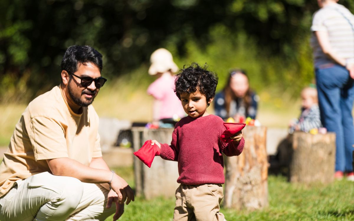 Adult and child playing outdoors