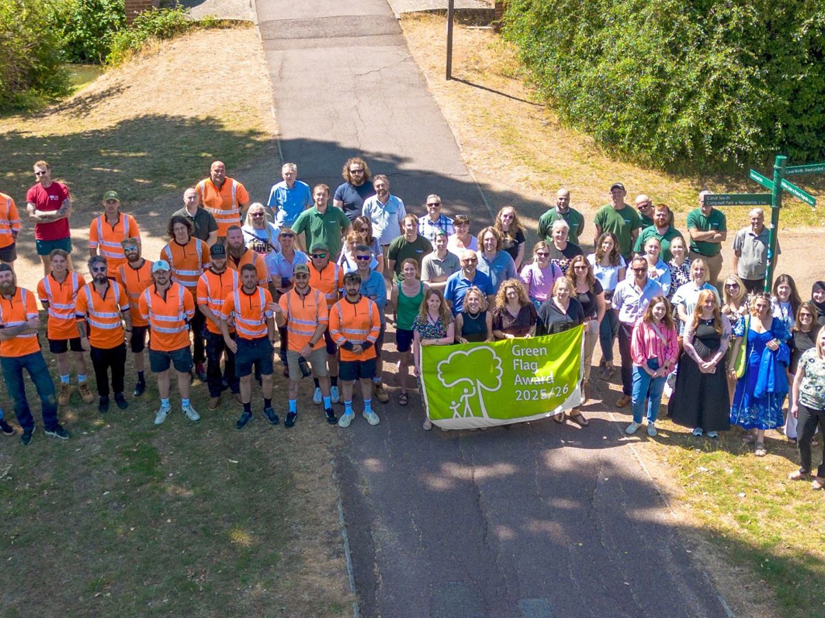 Group of Parks Trust staff with Green Flag Award banner