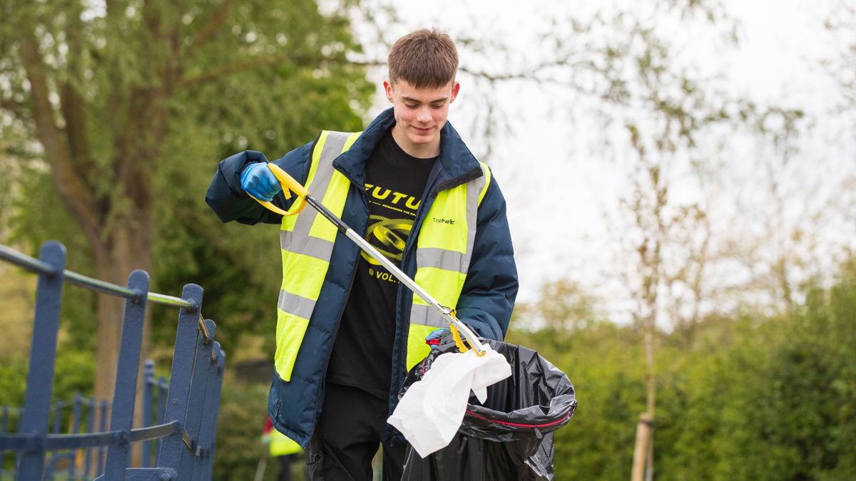 Person picking up litter in Campbell Park