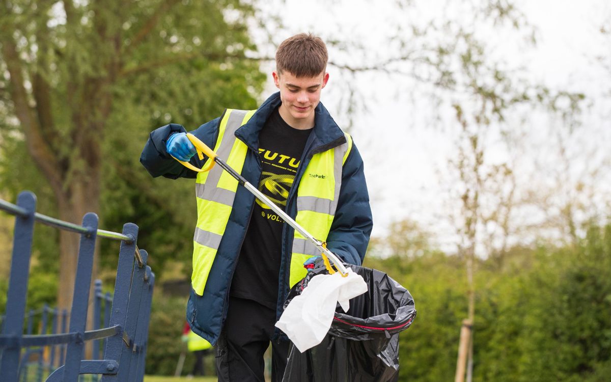 Person picking up litter in Campbell Park