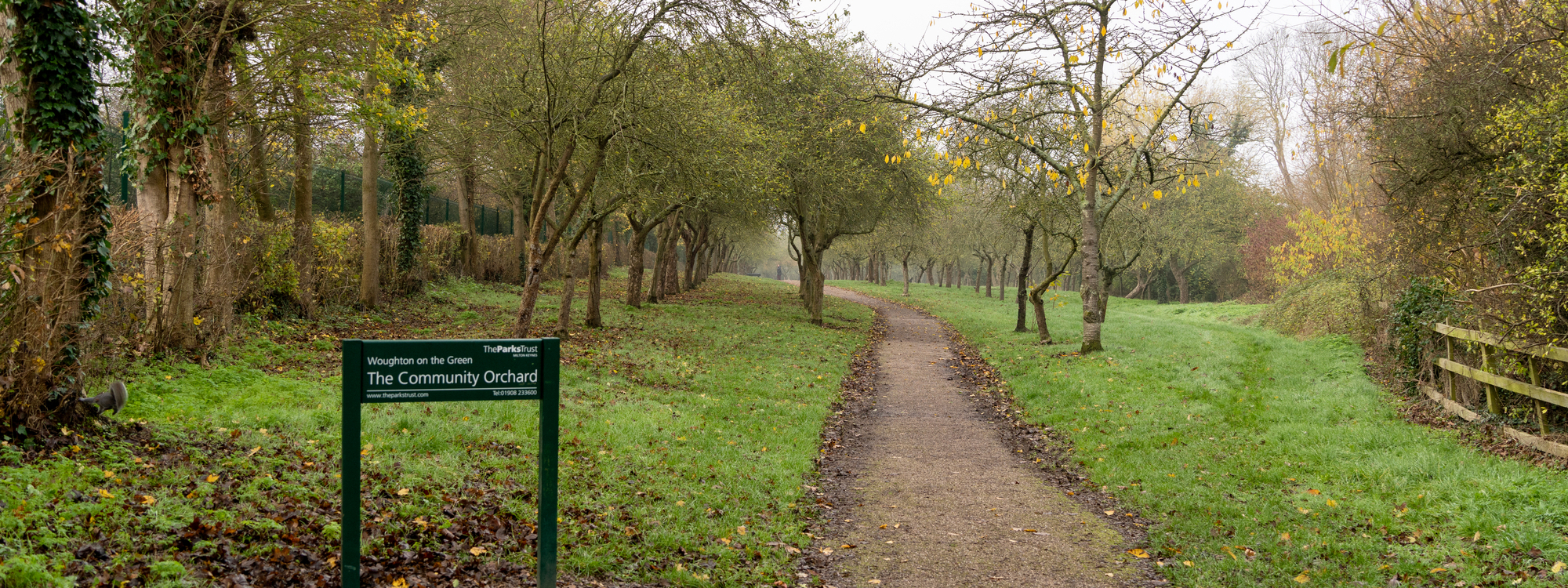 Woughton on the Orchard sign with path in winter