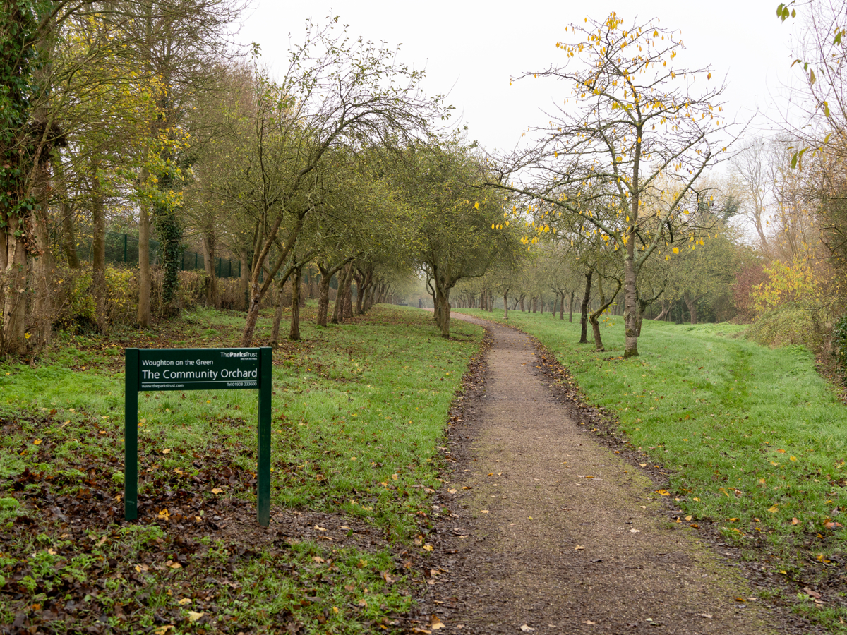 Woughton on the Orchard sign with path in winter