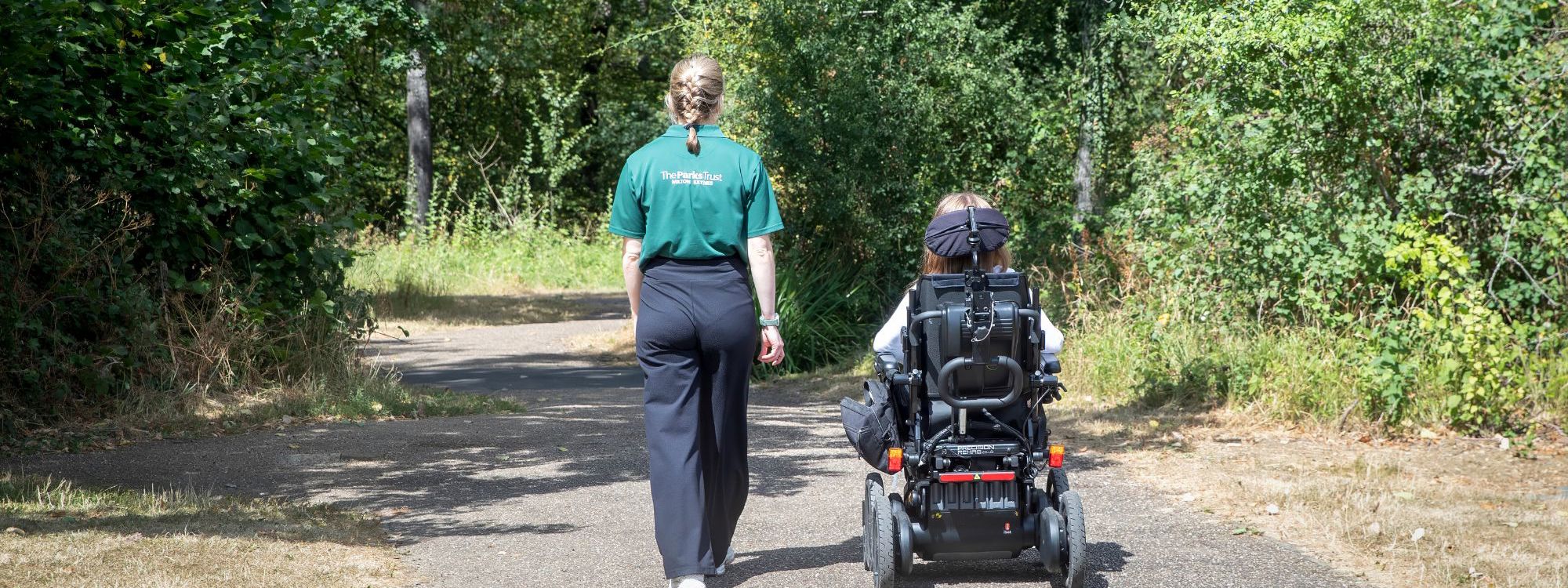 Park Trust Staff Member And Wheelchair User following path
