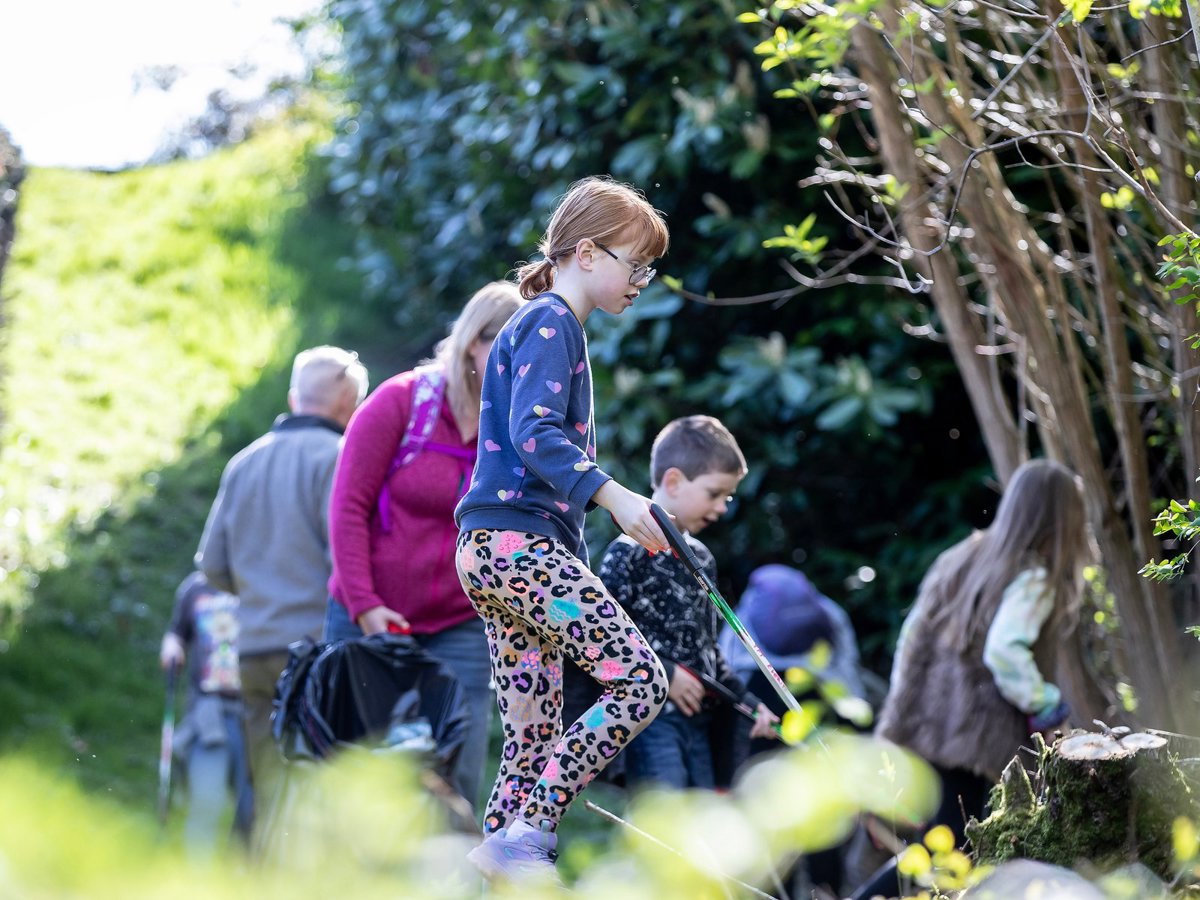 Youngsters litter picking in a parkland scene