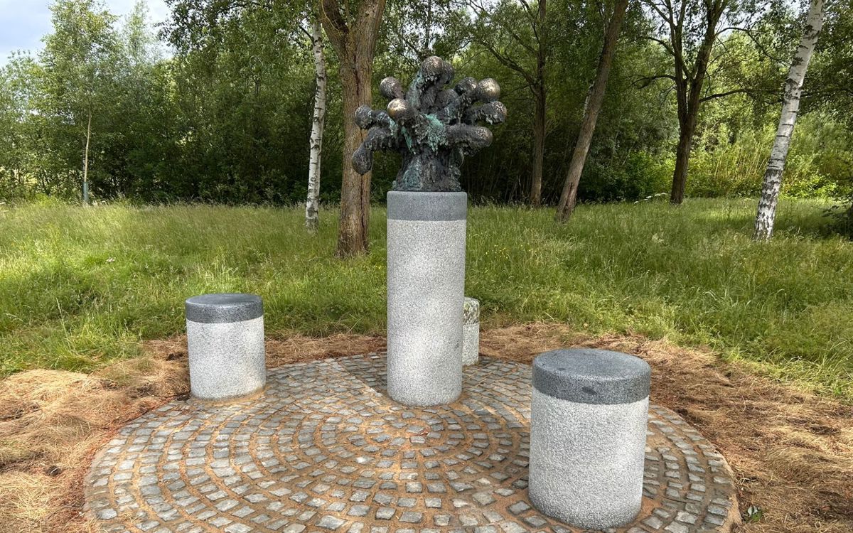 Art sculpture made on pedestal with stools around