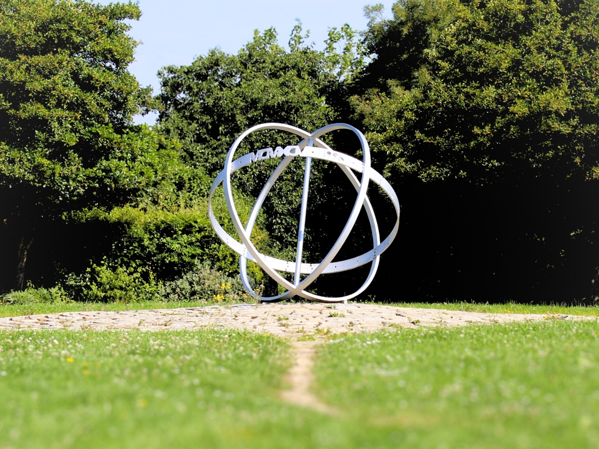 a metal sphere best descripted as flat metal lines combined creating a not full formed sphere