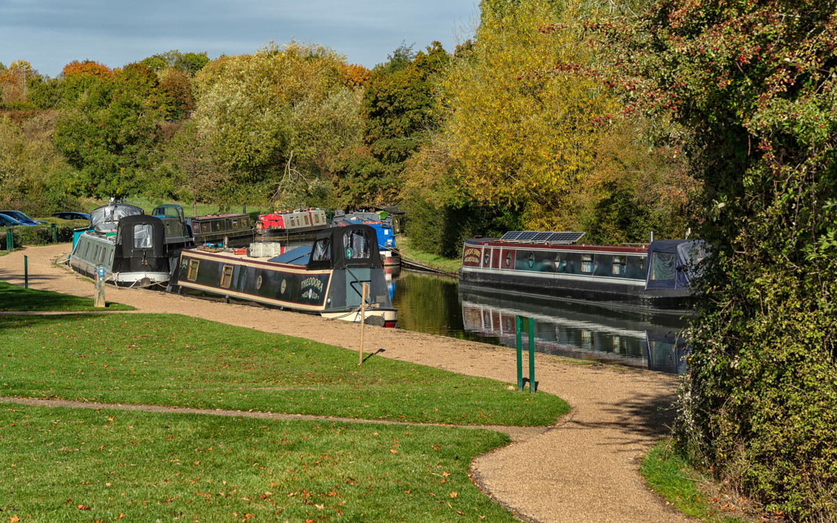 Narrowboats moored at canal along Canal Broadwalk.