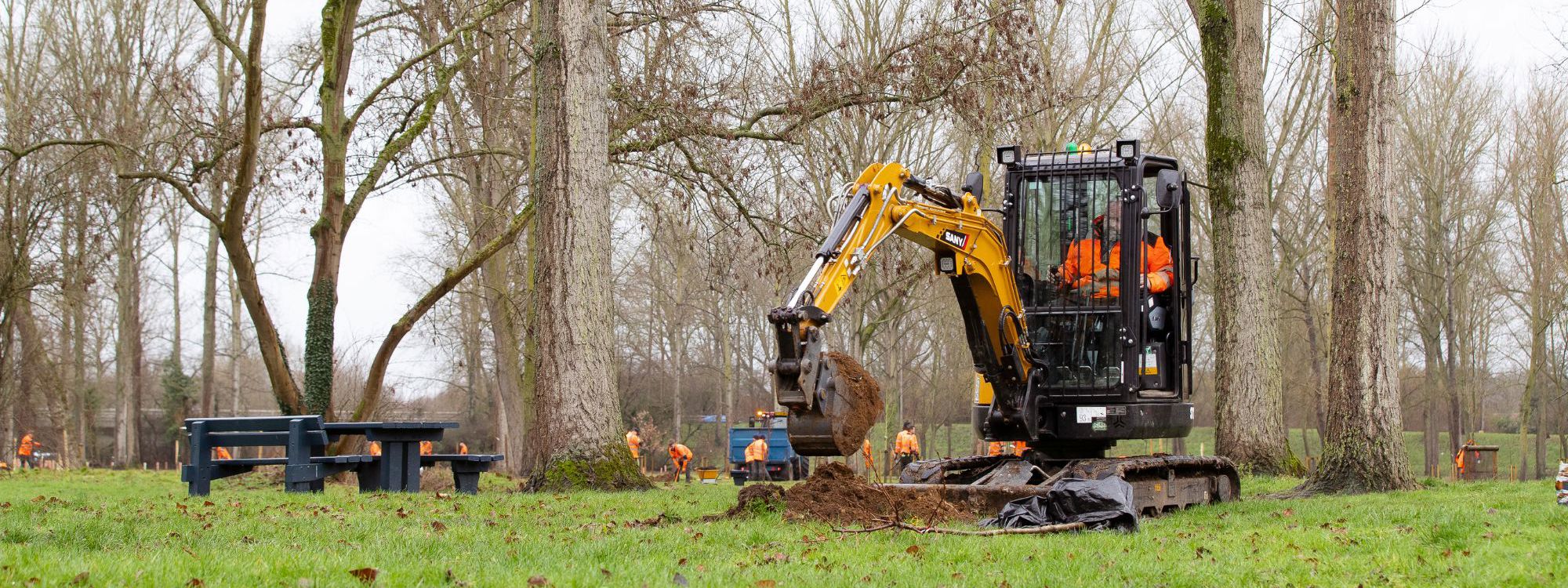 Digger removing mud in a park