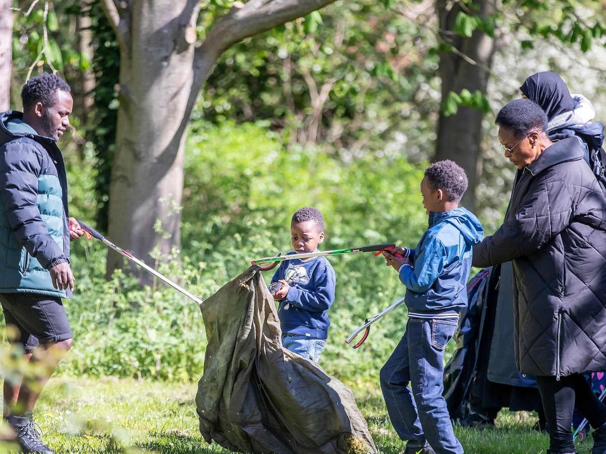 Youngsters litter picking in a parkland scene