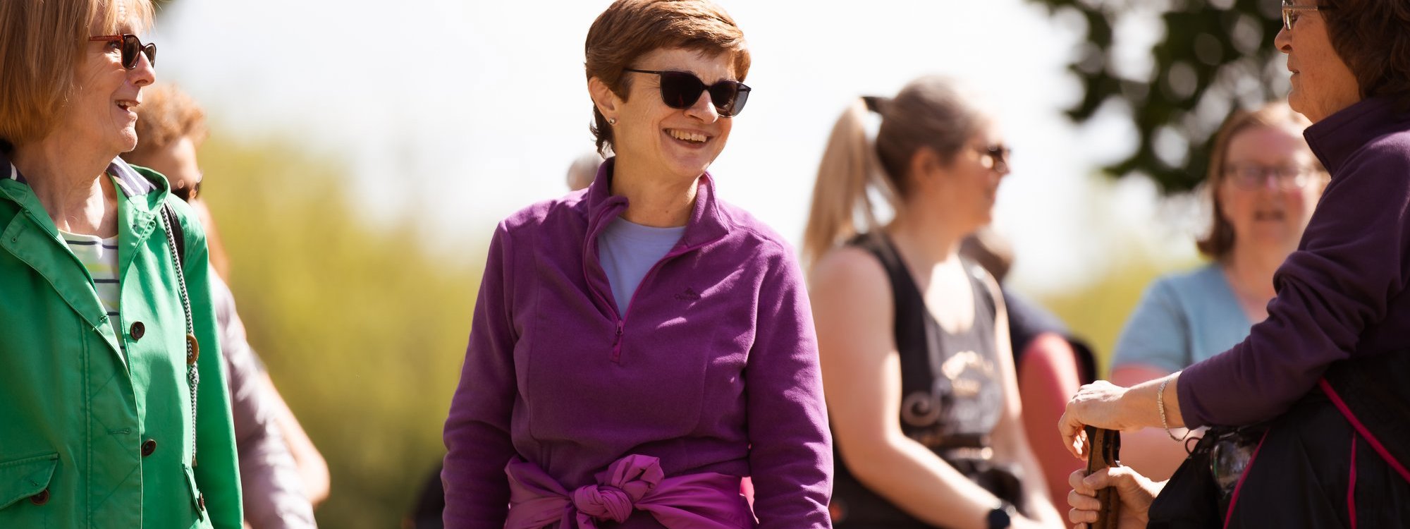 A group of women walking through parkland