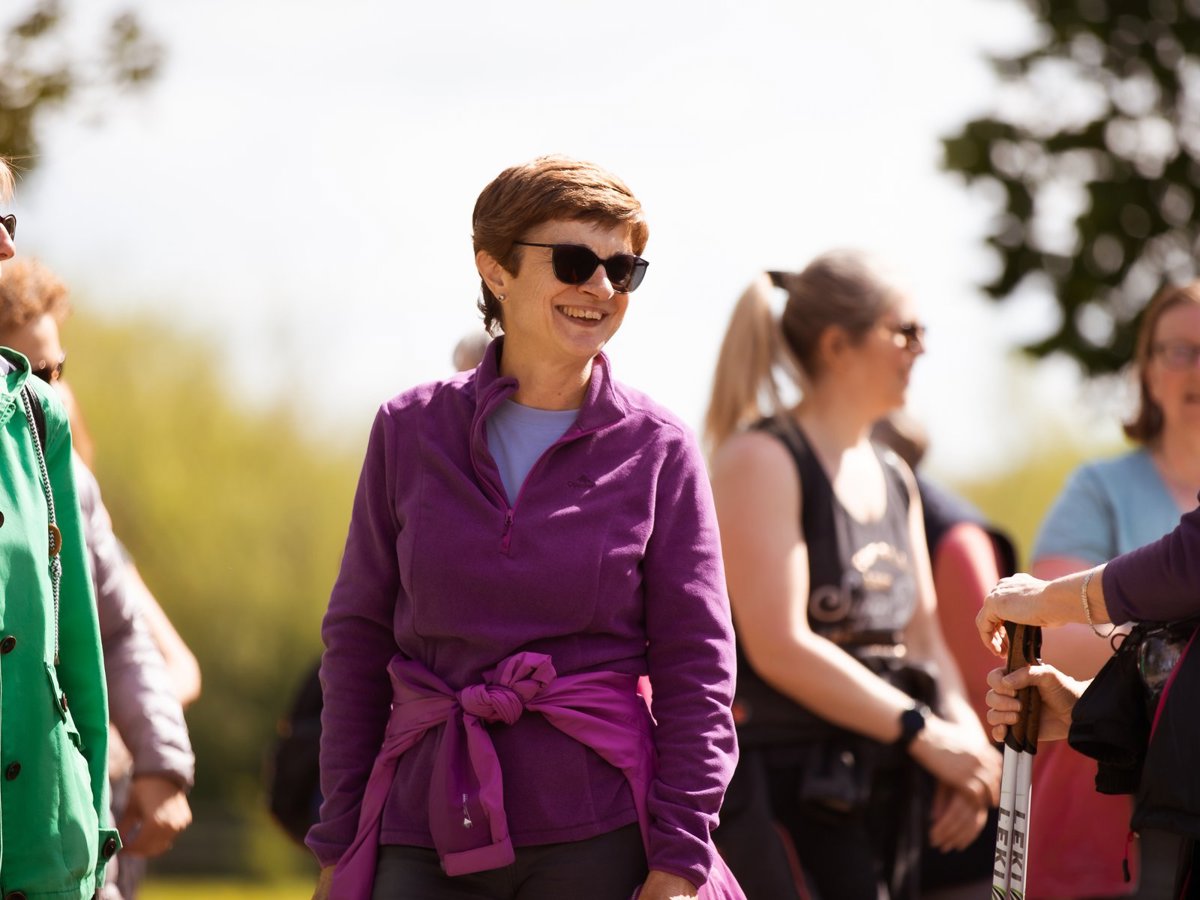 A group of women walking through parkland