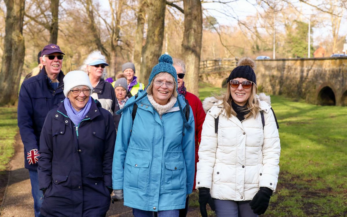 Group of people walking and smiling