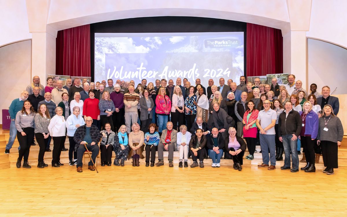 Group photo of staff and volunteers on stage
