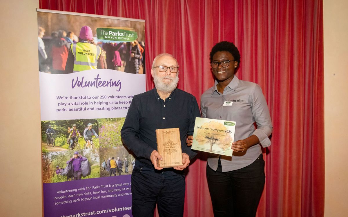 Frank and Sandra holding award and trophy