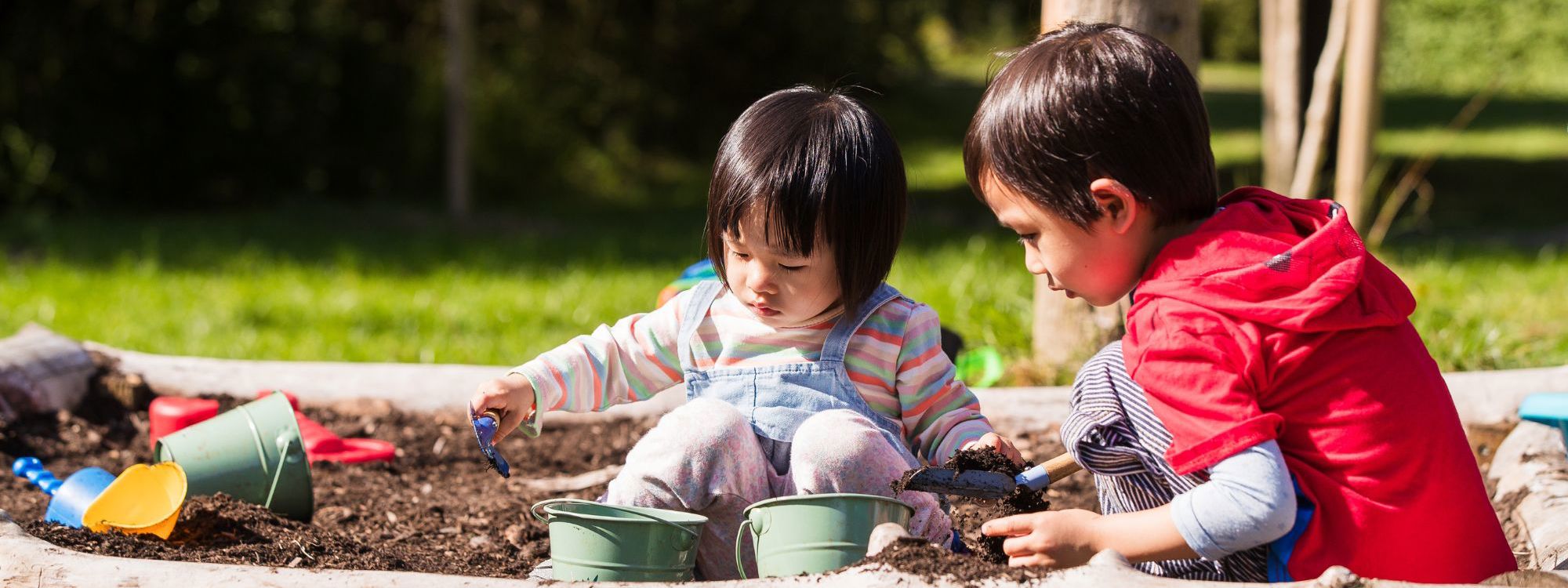 Two children playing in outdoor area