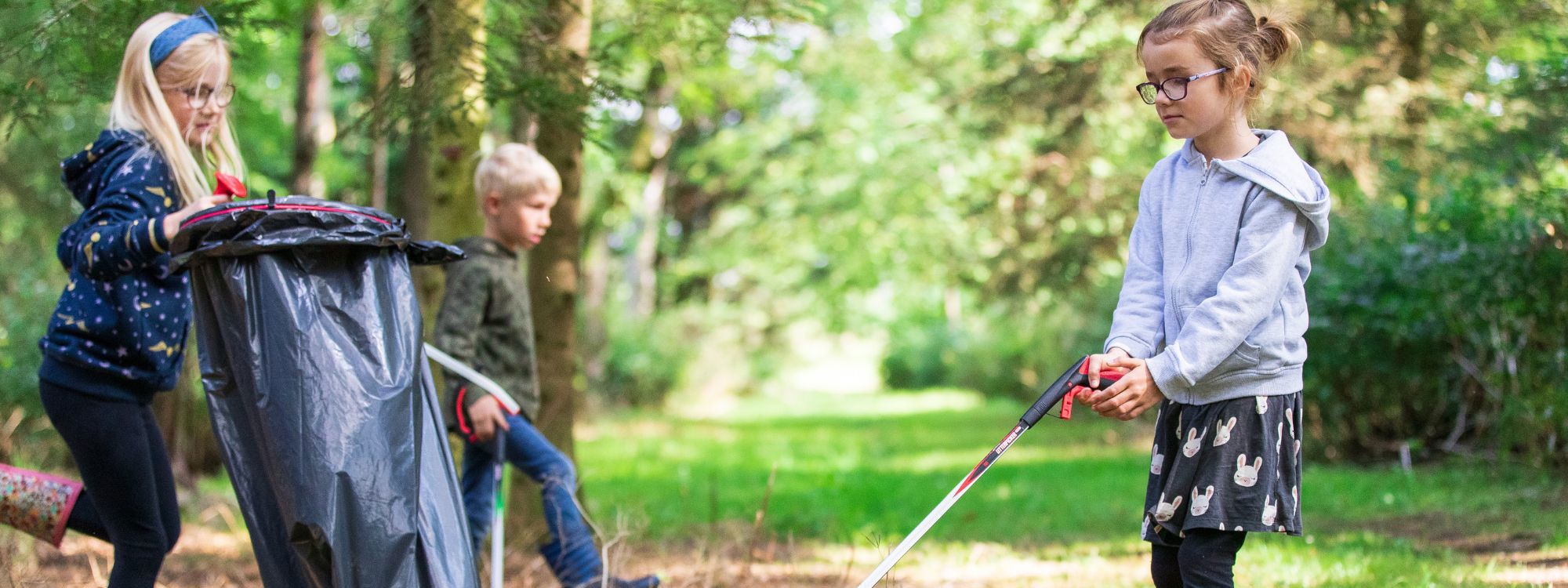 Children picking up litter from parkland