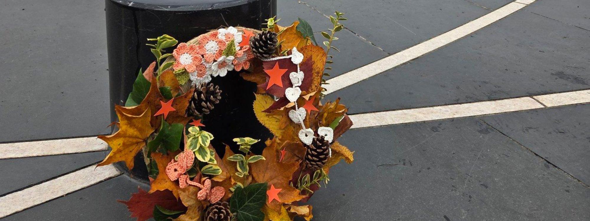 Orange And White Ribbon hand made wreath on Parks Trust pillar, at MK Rose