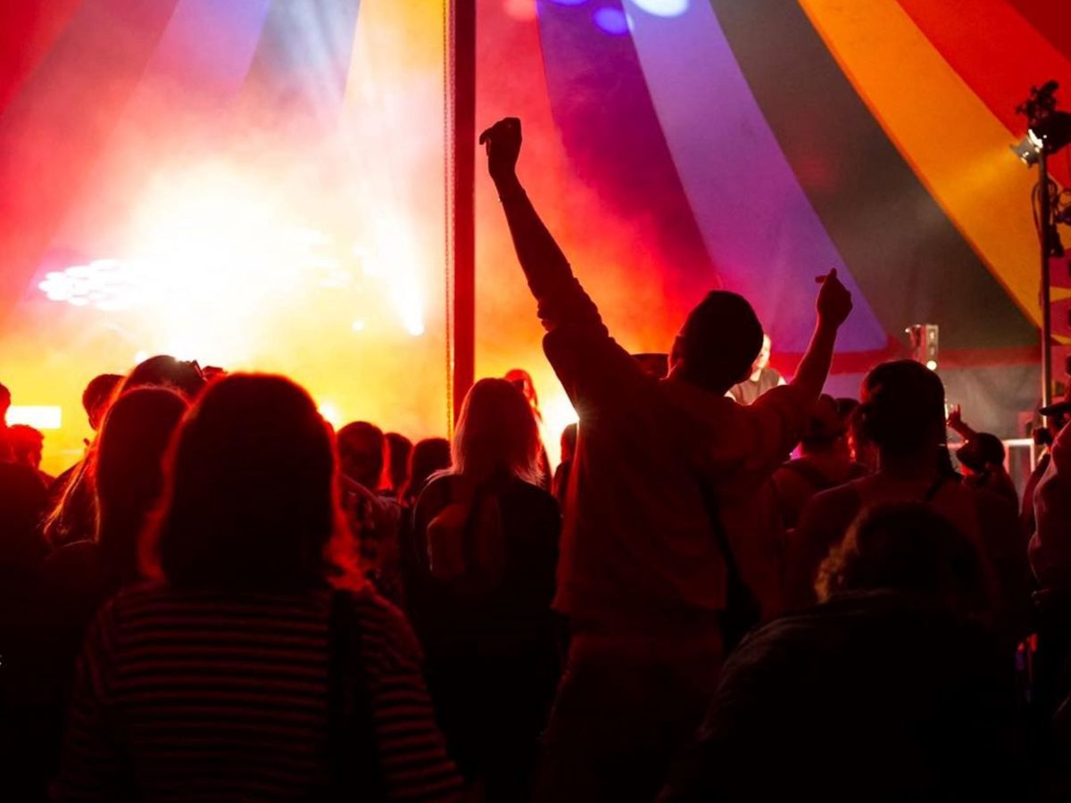 Crowd enjoying performance on stage in festival tent