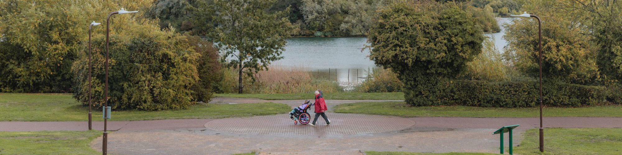 Family walking along path with lake behind
