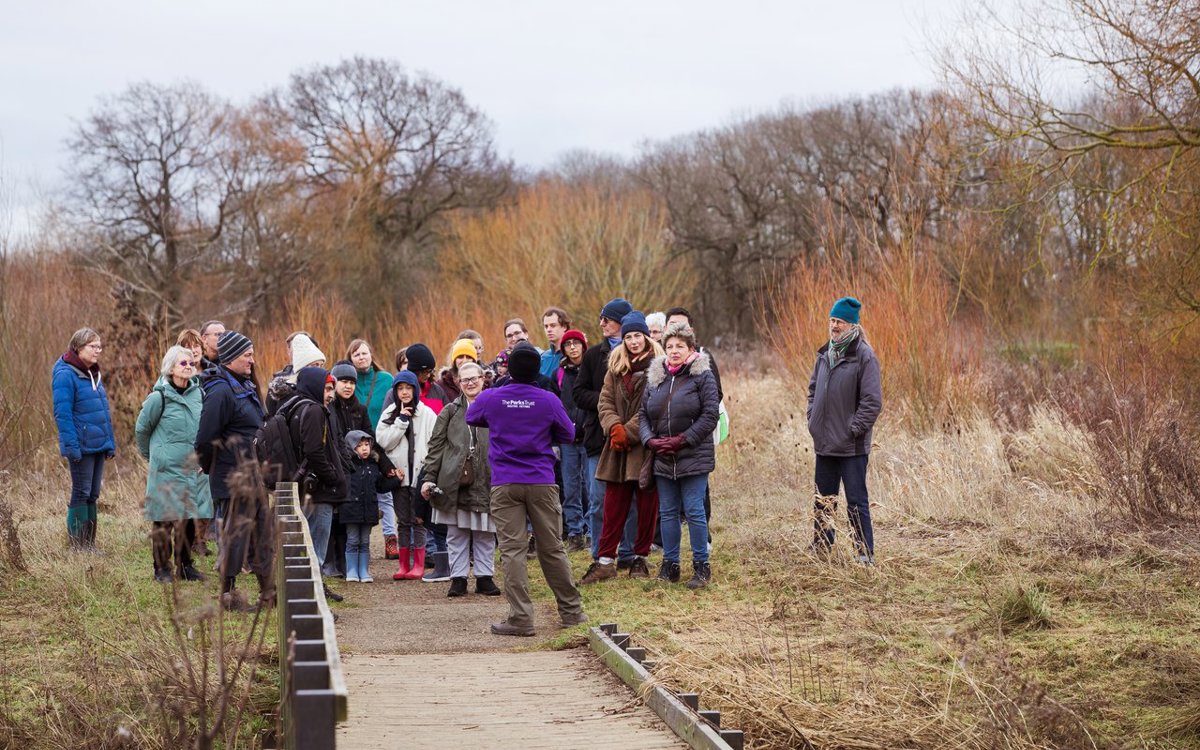 A guided walking group on a footbridge at Floodplain Forest Nature Reserve
