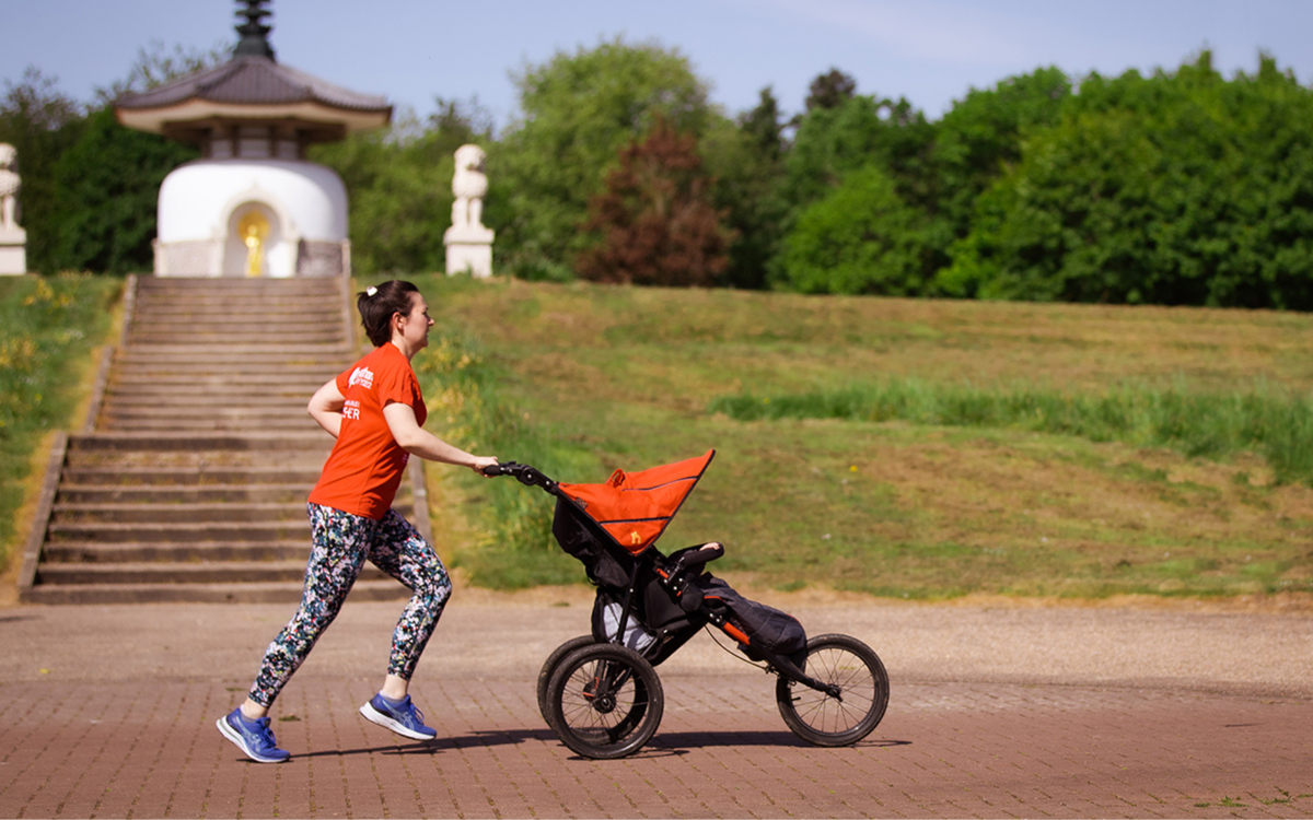 Person running with a pushchair along Redway by the Peace Pagoda