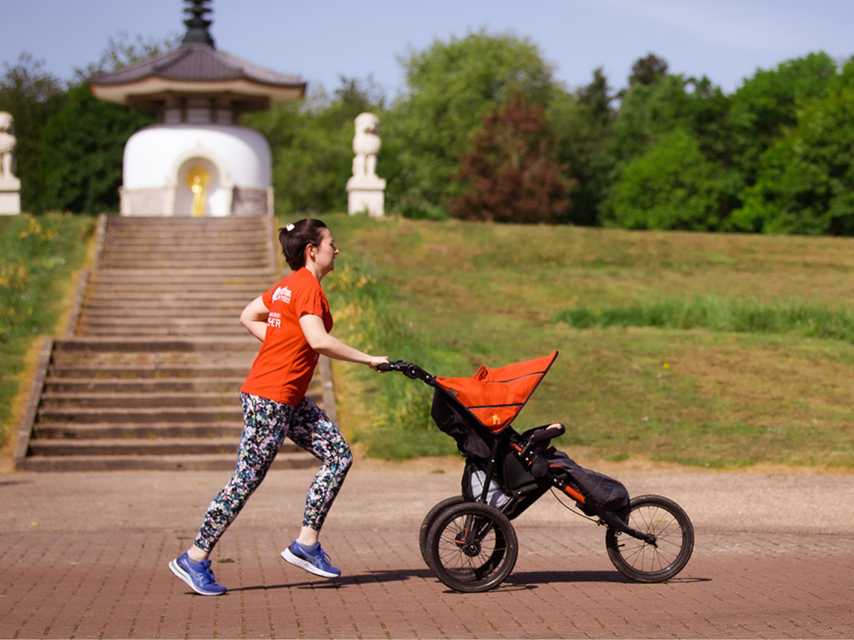 Person running with a pushchair along Redway by the Peace Pagoda