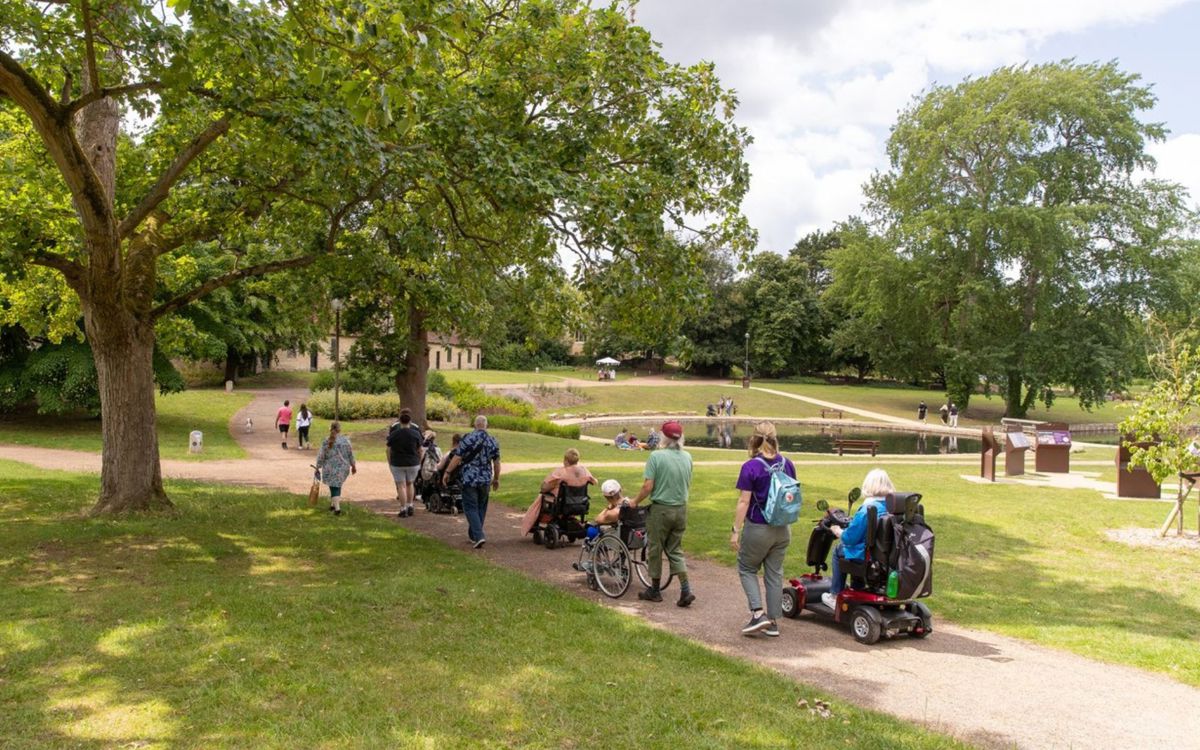 Group of people including wheelchair users in a park
