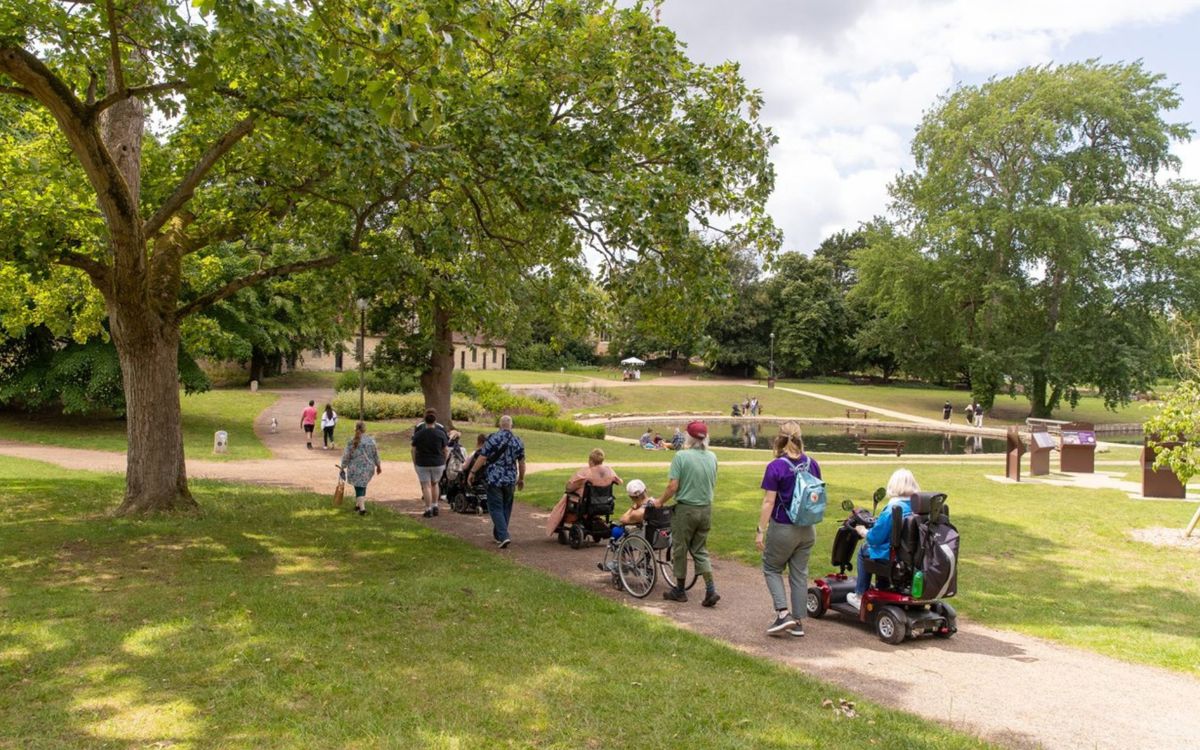 Group of people including wheelchair users in a park