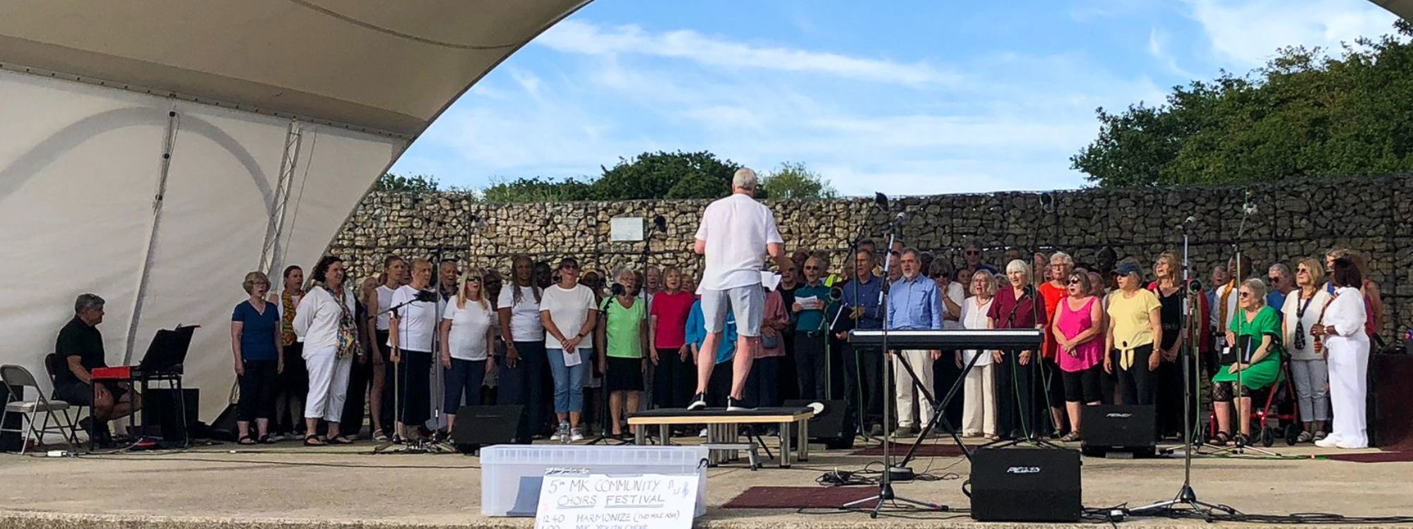 Choir singers and conductor performing on Stage at Choirs' Festival